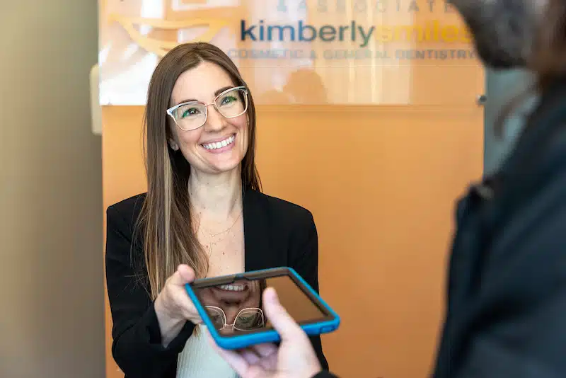 Front Desk, Tory, checking in a patient at Kimberly Smiles in Chicago, IL