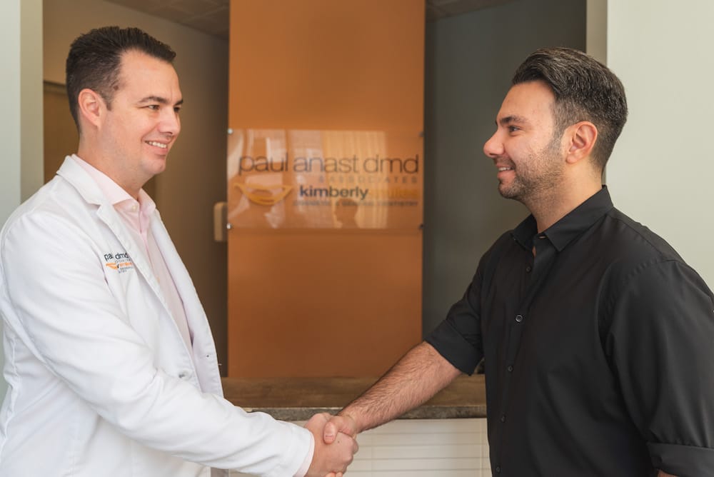 Dr. Paul Anast shaking hands with patient at Kimberly Smiles